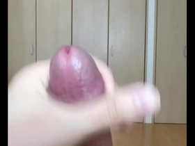 Close up of a man pleasuring himself with cum on his cock