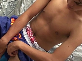 Gay Asian twink masturbates on camera.