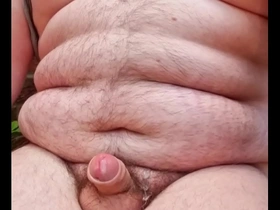 A gay man masturbates quickly outside.