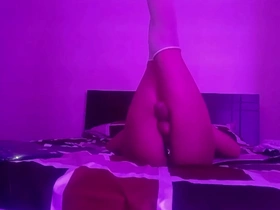 A beautiful boy in lingerie performs some erotic moves and exposes his behind and a sex toy.