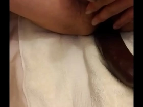 Asian man enjoys riding a big black dildo alone.