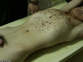 Young Asian man with a fit body is treated to hot wax in a BDSM scene.